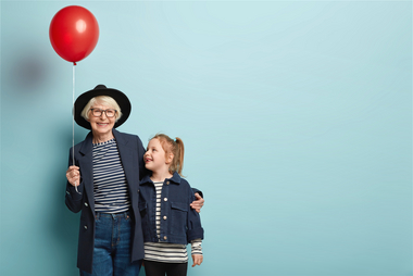 Oma mit Kind und Luftballon in der Hand