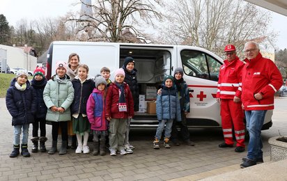Schülergruppe vor dem Lieferwagen bei der Warenübergabe