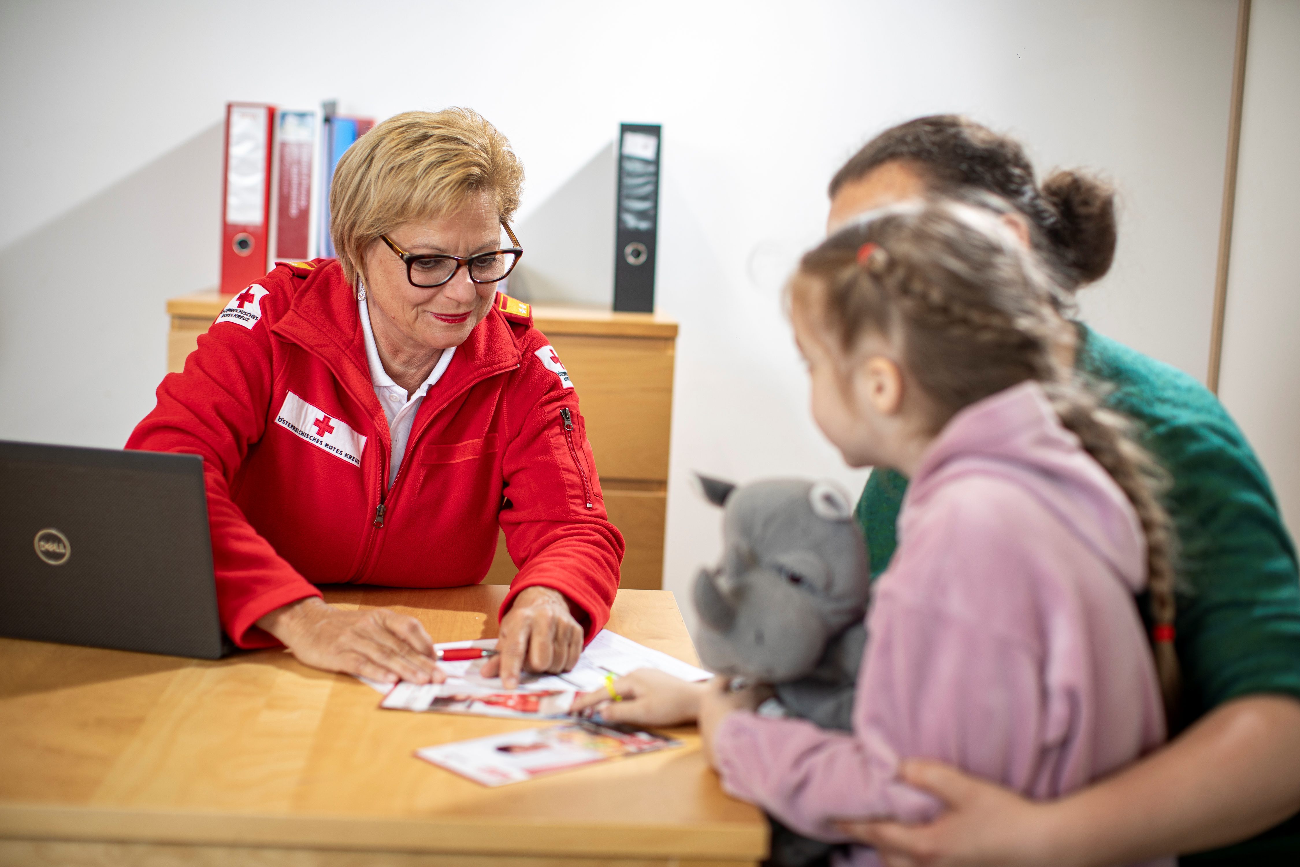 Rotkreuz-Mitarbeiterin betreut Kund:innen.