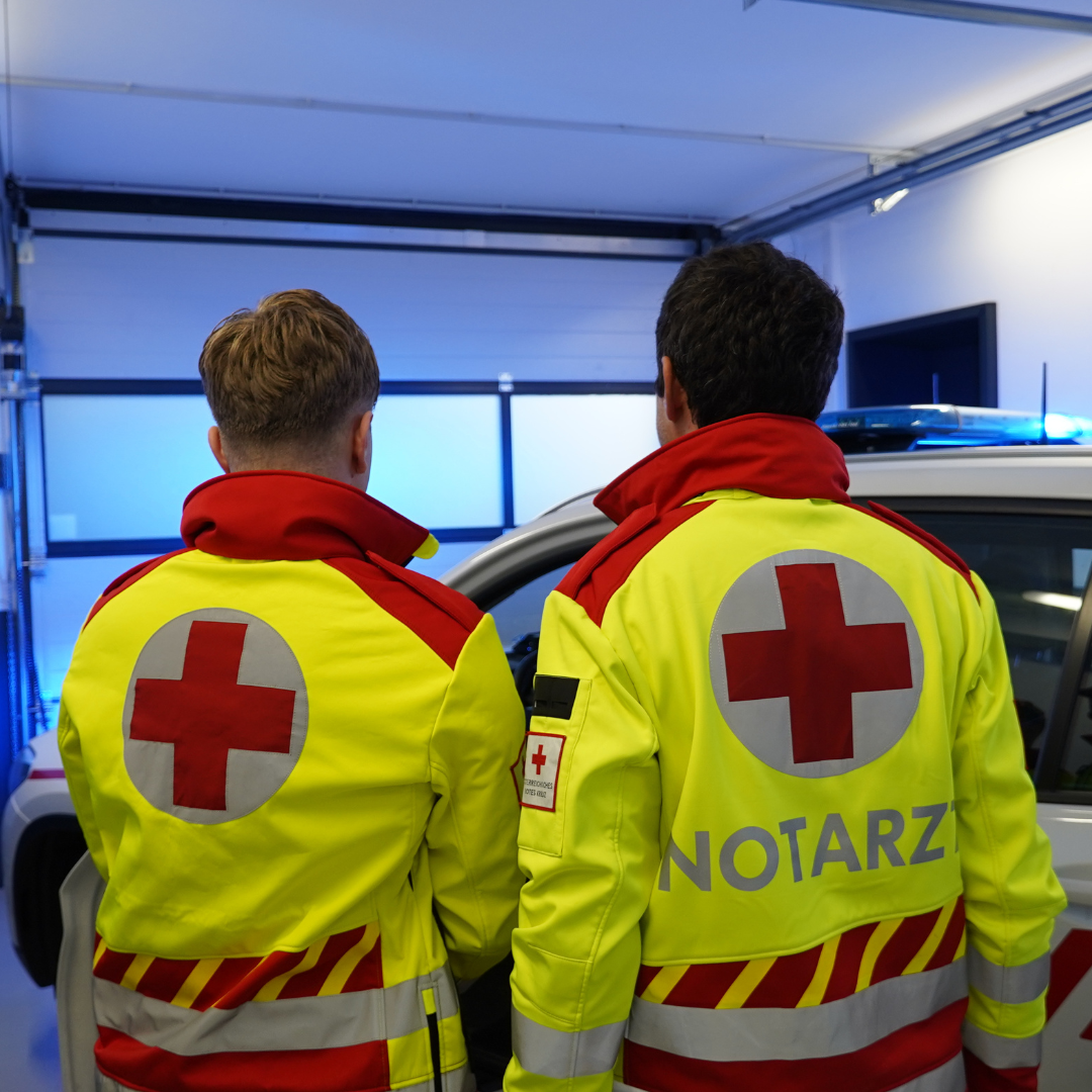 Sanitäter und Notarzt in Rotkreuz-Uniform