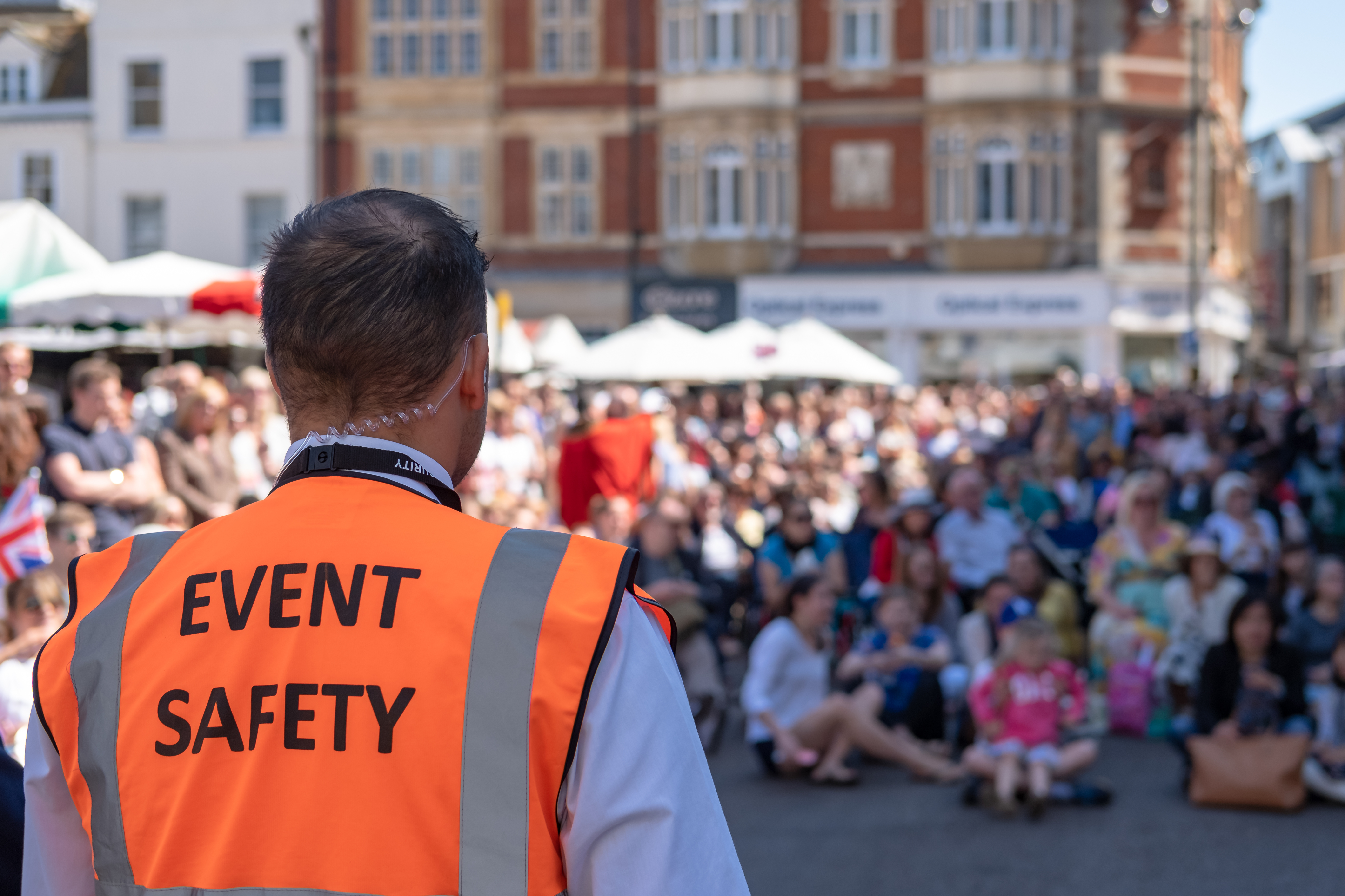 Shallow focus of an Event Safety officer seen facing members of - © NICK BEER